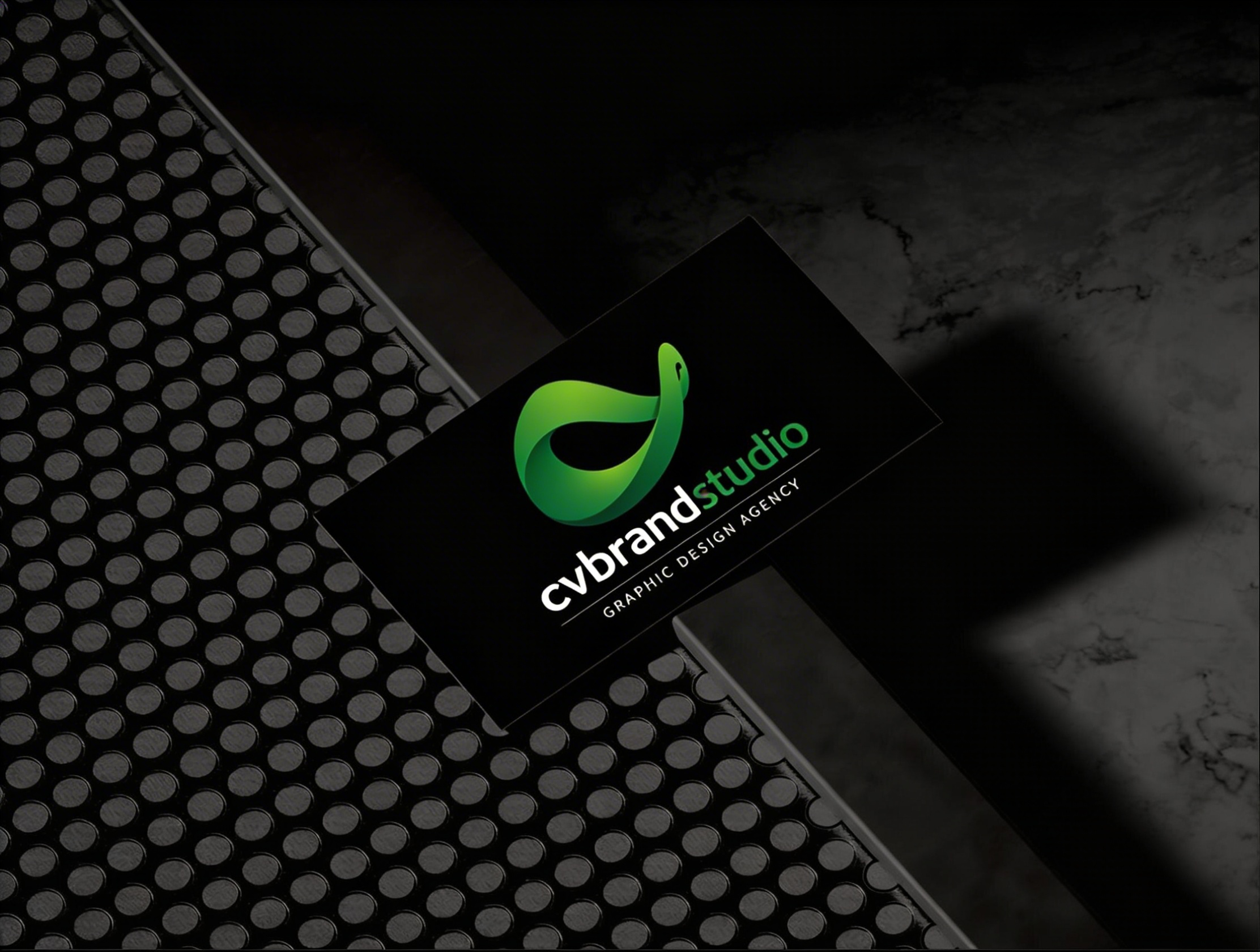 cvbrandstudio business card on dark textured surface